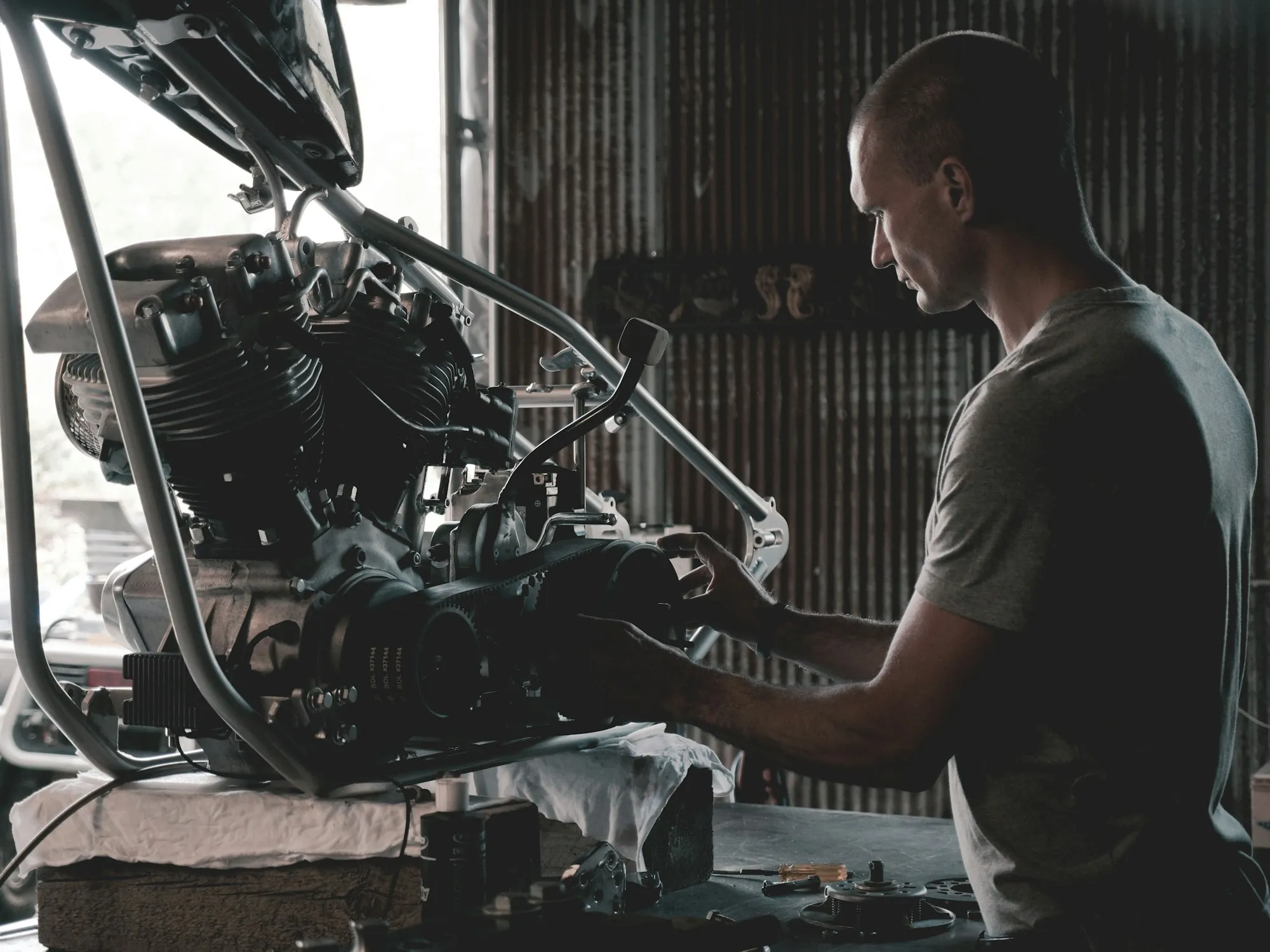Mechanic lifting a cylinder head out of an engine